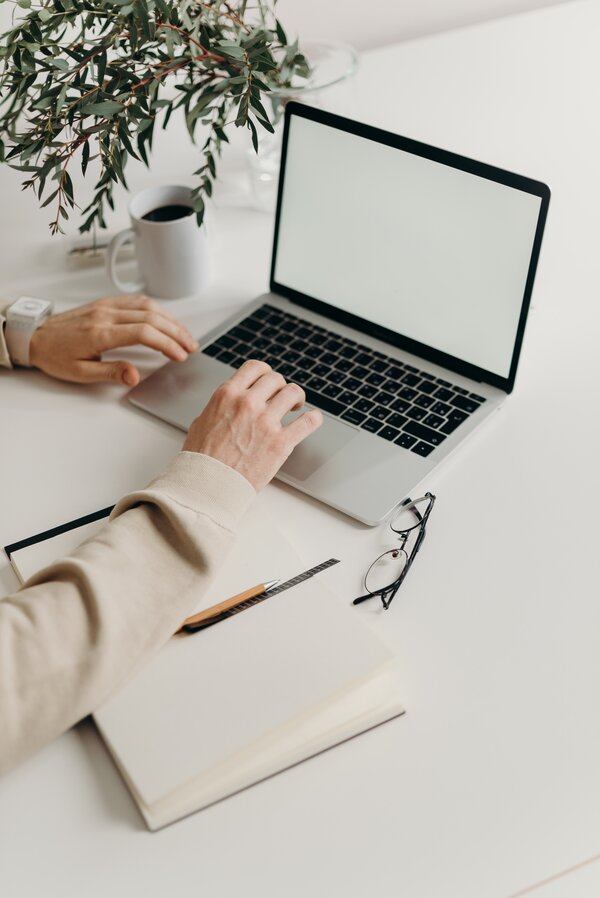 Photo by cottonbro: https://www.pexels.com/photo/person-using-macbook-pro-on-white-table-4065864/